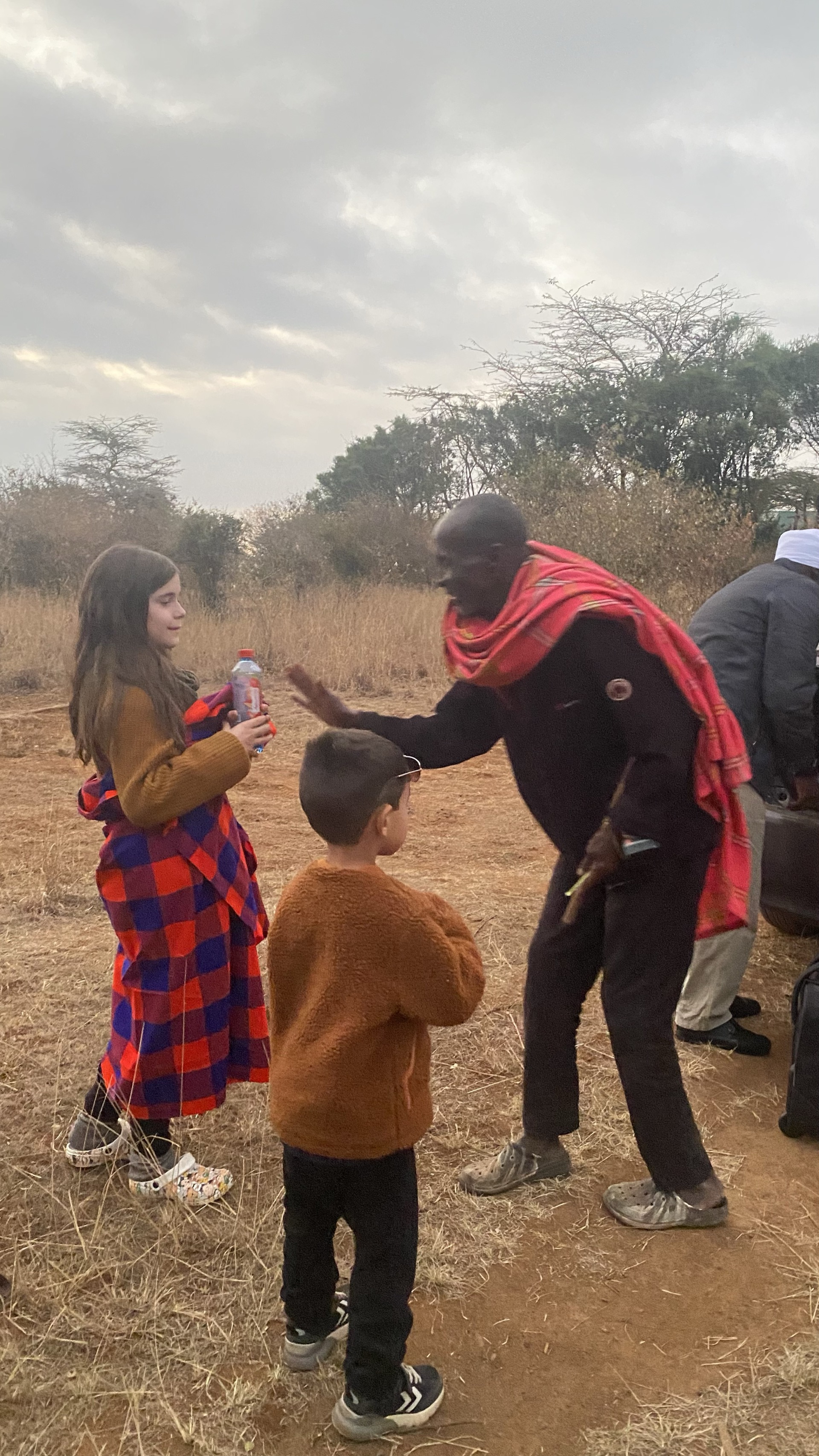 Maasai guide walking with guests through the bush at Silole Sanctuary